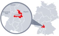 Diese Grafik zeigt eine Karte von Deutschland mit einer detaillierten Ansicht der Region Heilbronn-Franken. Heilbronn-Franken ist in Rot hervorgehoben und liegt im südlichen Teil Deutschlands. Ein Lupensymbol vergrößert diesen Bereich, um die Lage genauer darzustellen. 