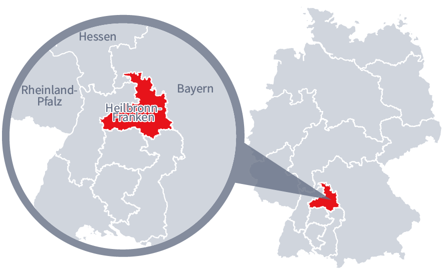 Diese Grafik zeigt eine Karte von Deutschland mit einer detaillierten Ansicht der Region Heilbronn-Franken. Heilbronn-Franken ist in Rot hervorgehoben und liegt im südlichen Teil Deutschlands. Ein Lupensymbol vergrößert diesen Bereich, um die Lage genauer darzustellen. 